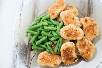 Chicken nuggets with beans, view from above, horizontal shot