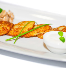 Potato pancakes with sauce and mushroom on plate, restaurant