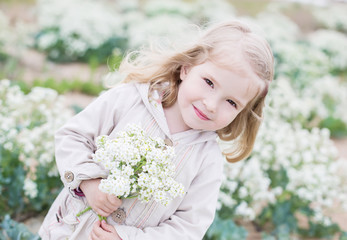 Adorable little girl holding a bouquet