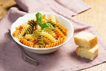 Spiral pasta with cheese on plate