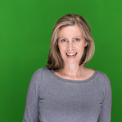 portrait einer attraktiven älteren frau vor grün