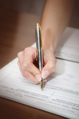 Woman writing on her agenda