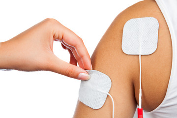 electrodes of tens device on shoulder, tens therapy, nerve stimu - obrazy, fototapety, plakaty