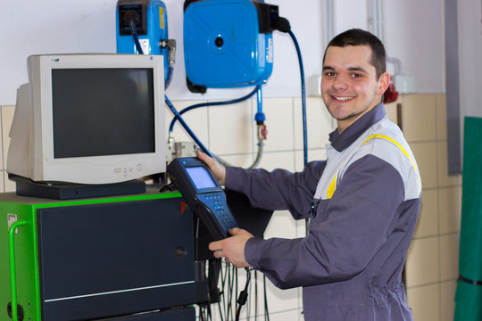 Professional car machanic smiling