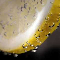 Lemon with bubbles on a black background.