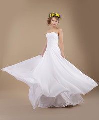 Fiancee with Vernal Wreath of Flowers in Flying Wedding Dress