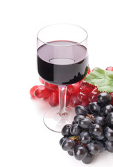 Glass of black wine and grapes on white background
