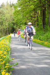 Obraz premium People cycling through countryside