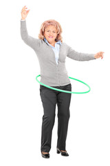 Mature woman spinning a hula hoop