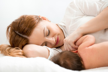 Fototapeta na wymiar happy mom breast feeding newborn baby