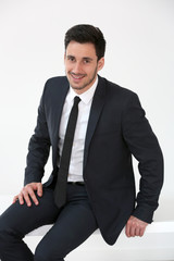 Relaxed businessman sitting on desk