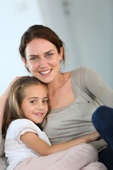 Portrait of mother and daughter in tender moment