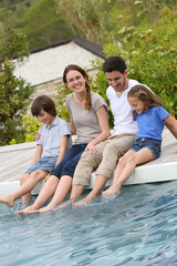 Parents with children relaxing by the pool