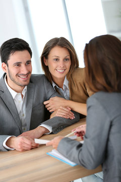 Couple meeting financial adviser for construction project