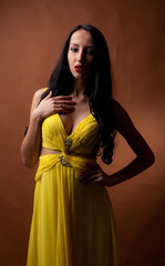 Fototapeta premium portrait of a beautiful girl in a yellow dress
