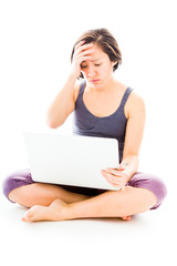 Fototapeta premium Young woman looking stressed using laptop