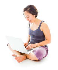 Fototapeta premium Young woman sitting on floor using laptop