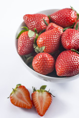 Fresh strawberry in bowl on white background closeup