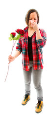 Young woman pinches her nose with holding rose