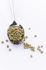 Green mung bean in spoon isolated on white background