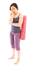 Young woman carrying exercise mat looking sad