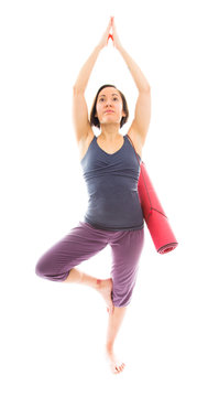 Young woman practicing yoga with carrying exercise mat