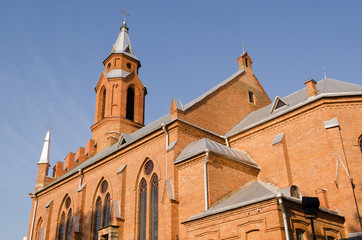 gothic church with crosses on blue sky background