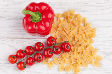 Tomatoes, red pepper and macaroni on table