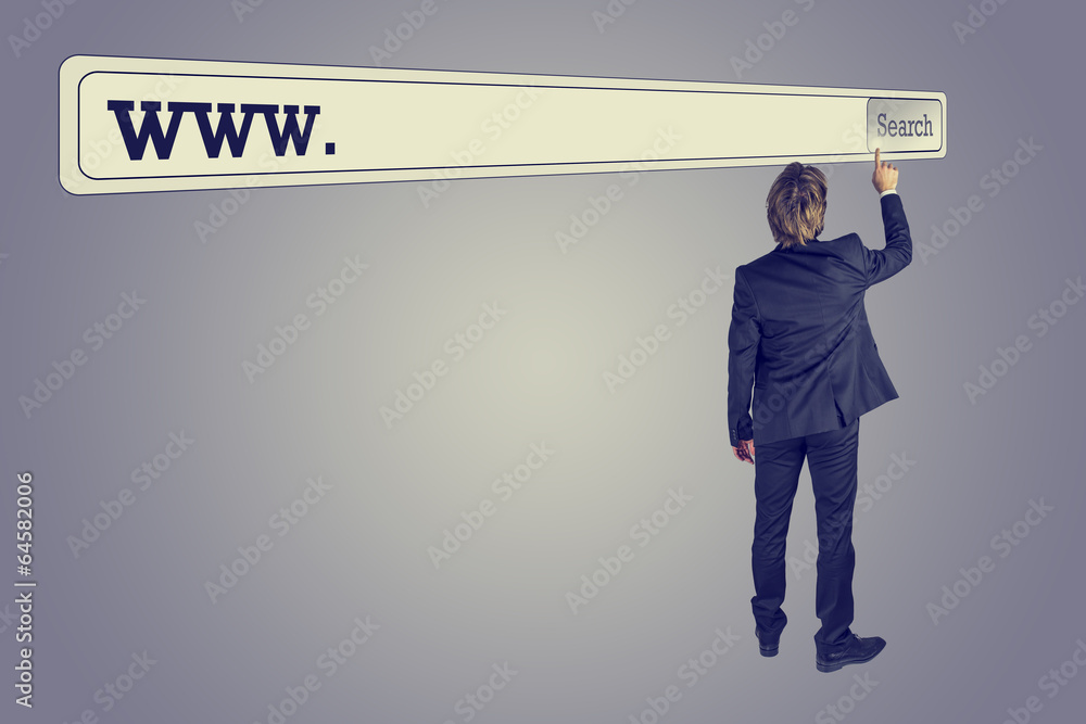 Wall mural man touching the button of a huge search bar