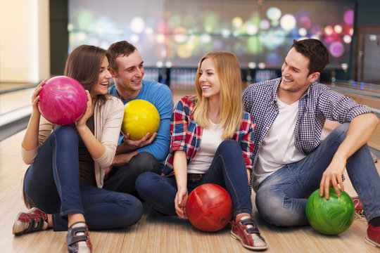 Young group of friends have fun at bowling alley