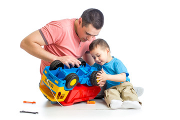 kid boy and his dad repair toy trunk © Oksana Kuzmina