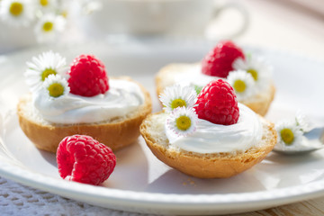 Brioche buns with creamy cheese and fresh raspberries