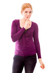 Young woman with finger on lips