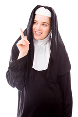 Young nun smiling and pointing up