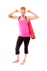 Young woman carrying exercising mat and looking frustrated