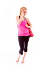 Young woman carrying exercising mat using fingers as glasses