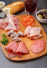 Antipasto with salami, cheese, bread and olives