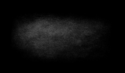 Black texture background with spotlight.