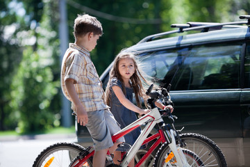 Young boy and girl taking a break from bicycling
