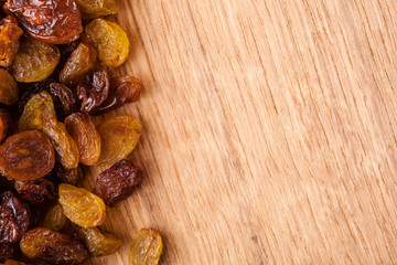 Diet healthy food. Border of raisin on wooden background