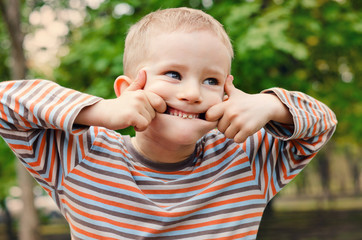 Cute young boy pulling a funny expression