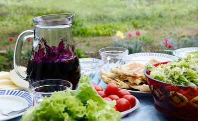 Summer still life with tomatos,wine,cheese and salad