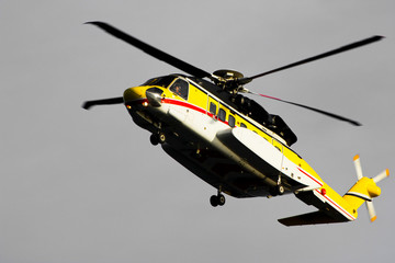 Fototapeta premium A helicopter transporting roughnecks to nearby rigs