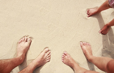 family footprints in the sand on the seashore
