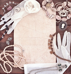 Frame with old women's jewelry and lacy white gloves