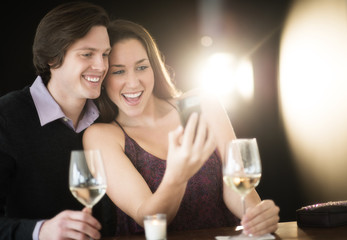 Couple Taking Selfie Through Smart Phone At Nightclub