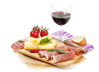 Red wine with cheese, prosciutto, bread, vegetables and spices