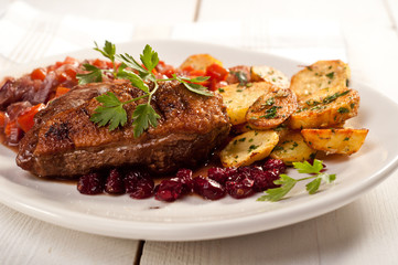 fillet of duck with roasted potatoes, vegetables and cranberry