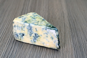 Cheese on Wooden Background