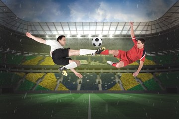 Obraz na płótnie Canvas Football players tackling for the ball